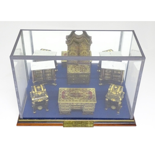 1497 - A showcase containing a display of early 21stC scale model miniature models of furniture to include ... 