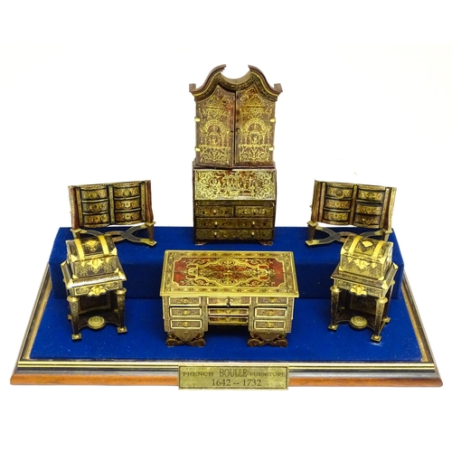 1497 - A showcase containing a display of early 21stC scale model miniature models of furniture to include ... 