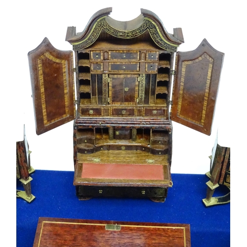 1497 - A showcase containing a display of early 21stC scale model miniature models of furniture to include ... 