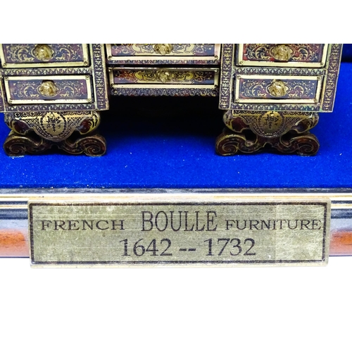 1497 - A showcase containing a display of early 21stC scale model miniature models of furniture to include ... 