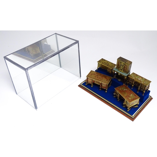 1498 - A showcase containing a display of early 21stC scale model miniature models of furniture to include ... 