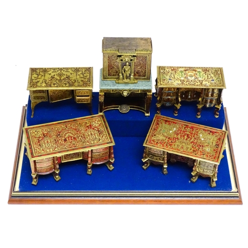 1498 - A showcase containing a display of early 21stC scale model miniature models of furniture to include ... 