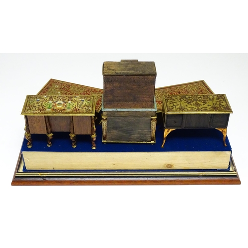 1498 - A showcase containing a display of early 21stC scale model miniature models of furniture to include ... 