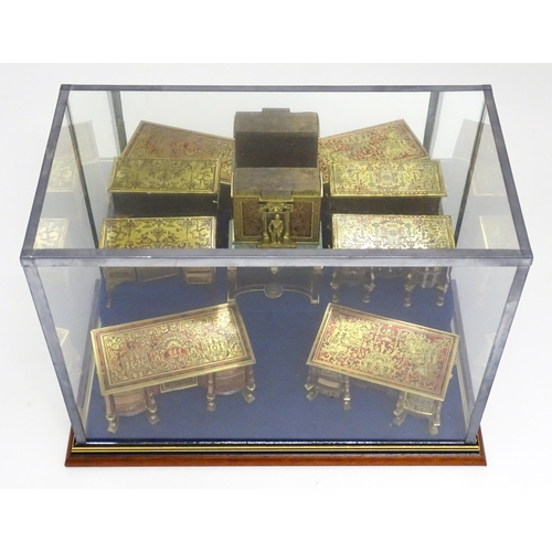 1498 - A showcase containing a display of early 21stC scale model miniature models of furniture to include ... 