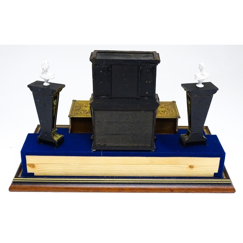 1499 - A showcase containing a display of early 21stC scale model miniature models of furniture to include ... 