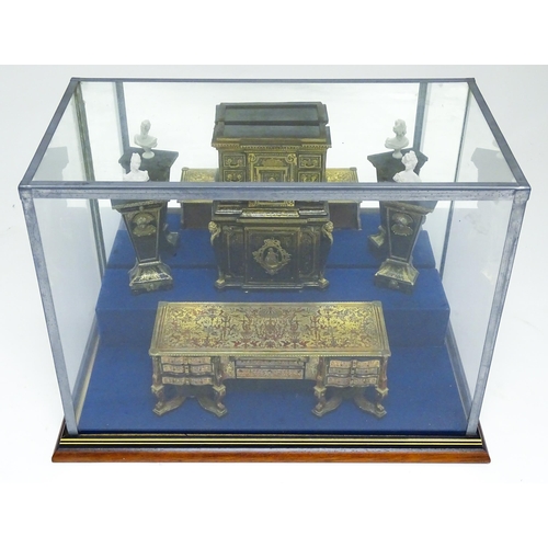 1499 - A showcase containing a display of early 21stC scale model miniature models of furniture to include ... 