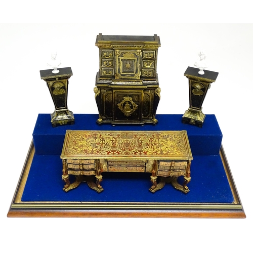 1499 - A showcase containing a display of early 21stC scale model miniature models of furniture to include ... 