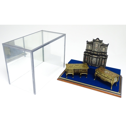 1500 - A showcase containing a display of early 21stC scale model miniature models of furniture to include ... 