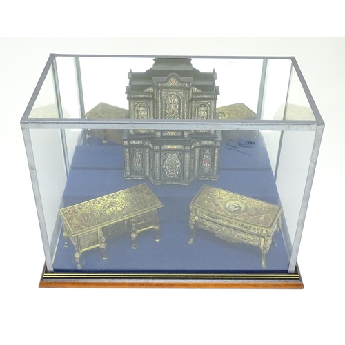 1500 - A showcase containing a display of early 21stC scale model miniature models of furniture to include ... 