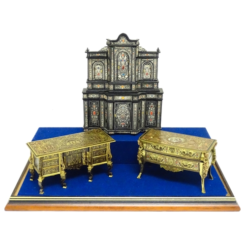 1500 - A showcase containing a display of early 21stC scale model miniature models of furniture to include ... 