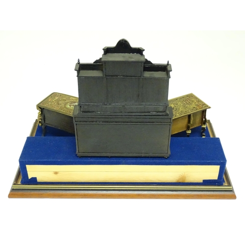 1500 - A showcase containing a display of early 21stC scale model miniature models of furniture to include ... 