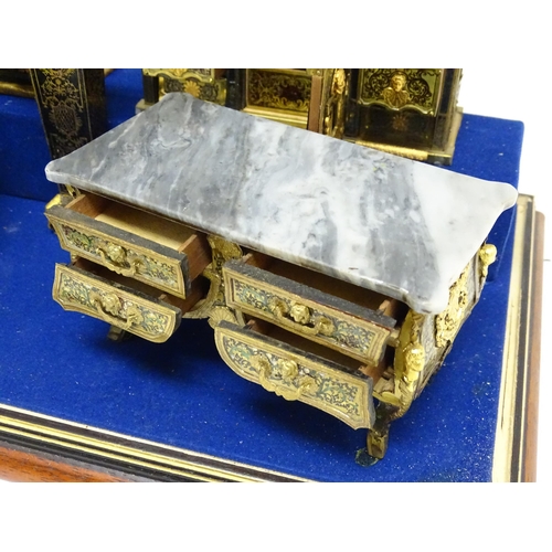 1501 - A showcase containing a display of early 21stC scale model miniature models of furniture to include ... 