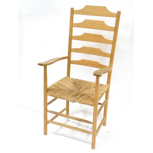 569 - A 19thC rush-seated ash ladderback chair, in stripped finish, approx 46