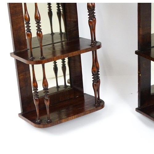 1744 - A pair of rosewood veneered mirrored wall shelves, each with four shelves supported by thin turned s... 