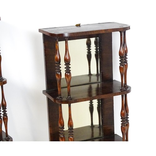 1744 - A pair of rosewood veneered mirrored wall shelves, each with four shelves supported by thin turned s... 