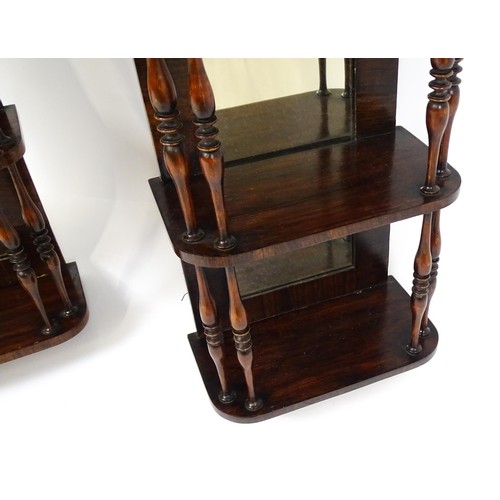 1744 - A pair of rosewood veneered mirrored wall shelves, each with four shelves supported by thin turned s... 