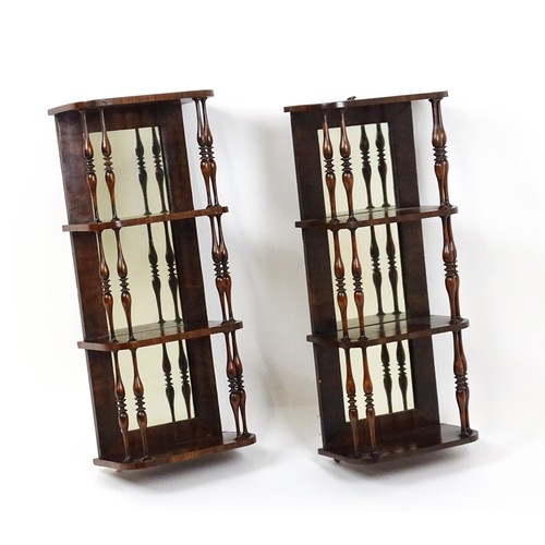 1744 - A pair of rosewood veneered mirrored wall shelves, each with four shelves supported by thin turned s... 