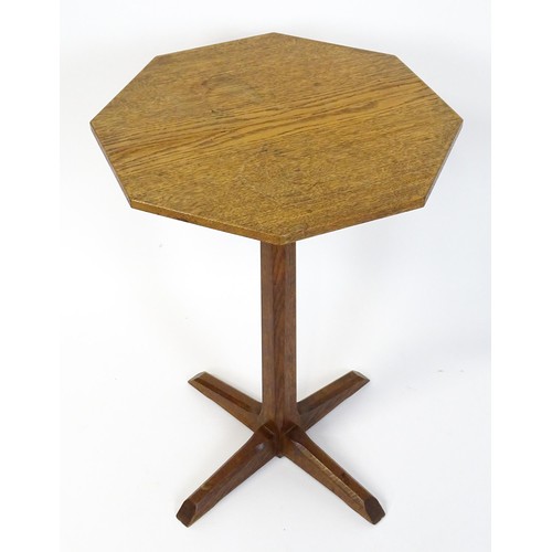 1832 - A late 19thC / early 20thC Cotswold school occasional table with an octagonal top raised on a canted... 