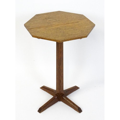 1832 - A late 19thC / early 20thC Cotswold school occasional table with an octagonal top raised on a canted... 