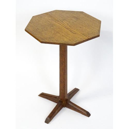 1832 - A late 19thC / early 20thC Cotswold school occasional table with an octagonal top raised on a canted... 