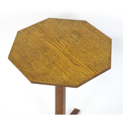 1832 - A late 19thC / early 20thC Cotswold school occasional table with an octagonal top raised on a canted... 