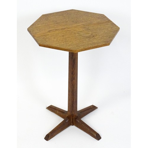 1832 - A late 19thC / early 20thC Cotswold school occasional table with an octagonal top raised on a canted... 