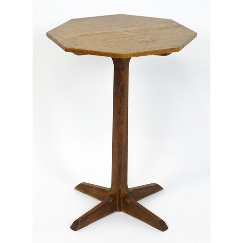 1832 - A late 19thC / early 20thC Cotswold school occasional table with an octagonal top raised on a canted... 