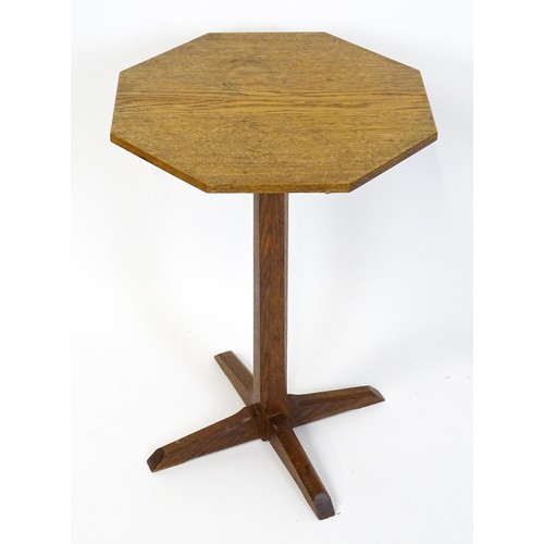 1832 - A late 19thC / early 20thC Cotswold school occasional table with an octagonal top raised on a canted... 