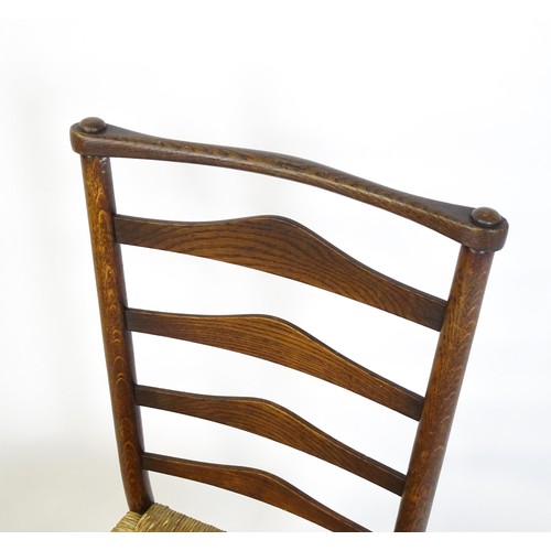 1833 - A pair of late 19thC Arts & Crafts ladderback chairs with graduated back rails above envelope rush s... 