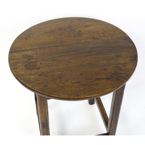 1832A - An 18thC tavern table with a circular top above a peg jointed base of four straight  chamfered legs ... 