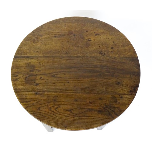 1832A - An 18thC tavern table with a circular top above a peg jointed base of four straight  chamfered legs ... 