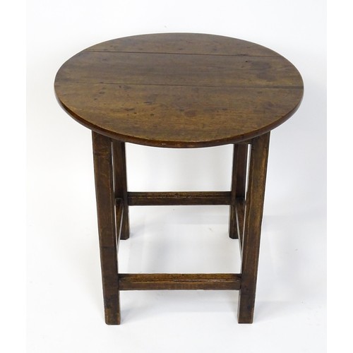 1832A - An 18thC tavern table with a circular top above a peg jointed base of four straight  chamfered legs ... 