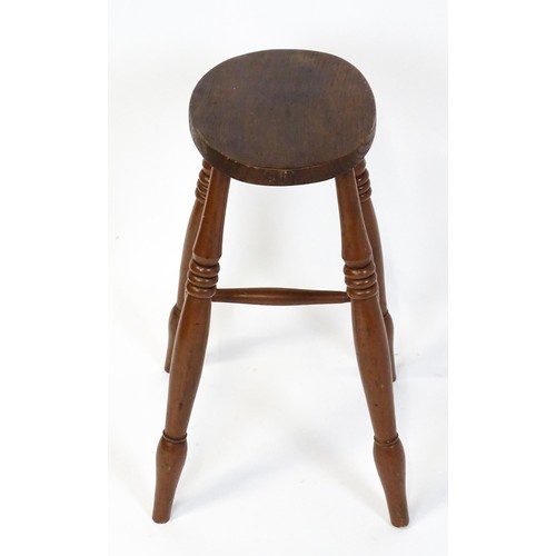 1753A - A 19thC high stool with an oval top raised on four turned tapering legs united by a H - stretcher. 1... 