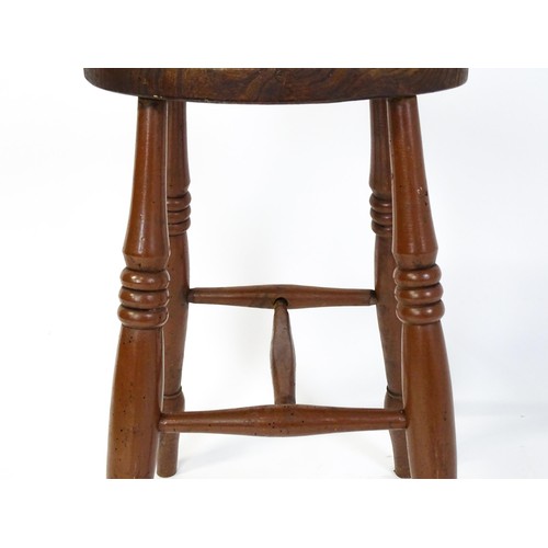 1753A - A 19thC high stool with an oval top raised on four turned tapering legs united by a H - stretcher. 1... 