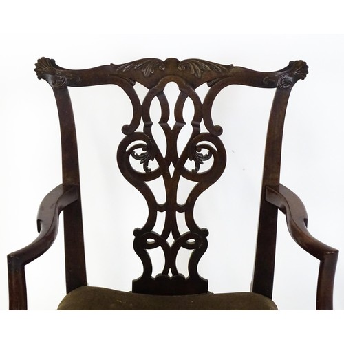 1865A - An 18thC Irish Chippendale armchair of mahogany construction, having a carved, flared cresting rail ... 