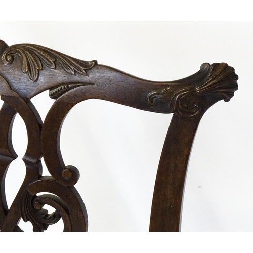 1865A - An 18thC Irish Chippendale armchair of mahogany construction, having a carved, flared cresting rail ... 