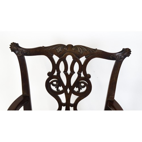 1865A - An 18thC Irish Chippendale armchair of mahogany construction, having a carved, flared cresting rail ... 