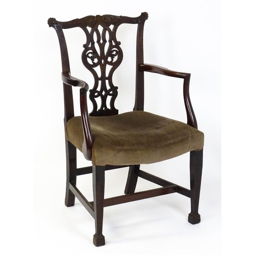 1865A - An 18thC Irish Chippendale armchair of mahogany construction, having a carved, flared cresting rail ... 