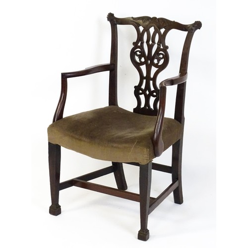 1865A - An 18thC Irish Chippendale armchair of mahogany construction, having a carved, flared cresting rail ... 