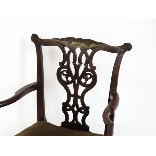 1865A - An 18thC Irish Chippendale armchair of mahogany construction, having a carved, flared cresting rail ... 