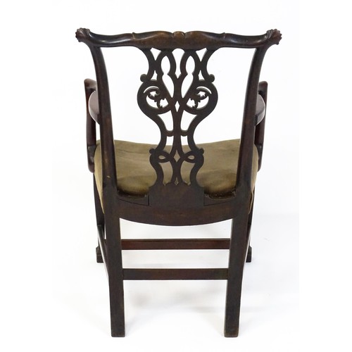 1865A - An 18thC Irish Chippendale armchair of mahogany construction, having a carved, flared cresting rail ... 