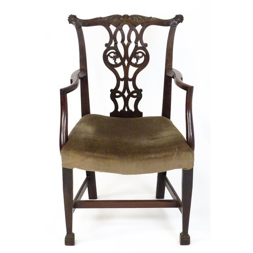 1865A - An 18thC Irish Chippendale armchair of mahogany construction, having a carved, flared cresting rail ... 