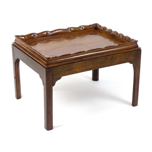 1745A - A Georgian Irish tray top table with a scrolled carved tray raised on a peg jointed base. 29