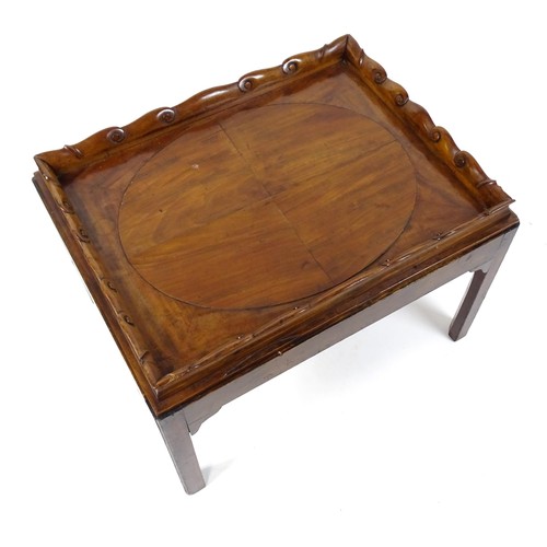 1745A - A Georgian Irish tray top table with a scrolled carved tray raised on a peg jointed base. 29