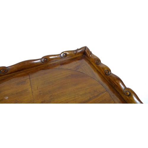 1745A - A Georgian Irish tray top table with a scrolled carved tray raised on a peg jointed base. 29