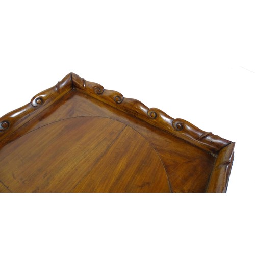 1745A - A Georgian Irish tray top table with a scrolled carved tray raised on a peg jointed base. 29