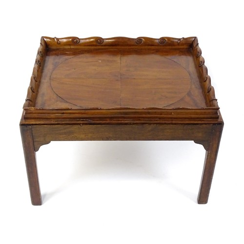 1745A - A Georgian Irish tray top table with a scrolled carved tray raised on a peg jointed base. 29