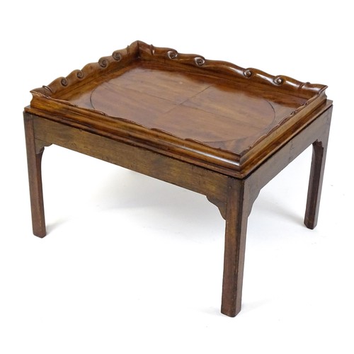 1745A - A Georgian Irish tray top table with a scrolled carved tray raised on a peg jointed base. 29