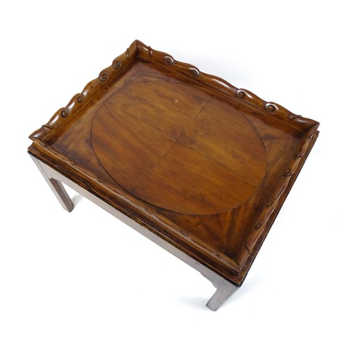 1745A - A Georgian Irish tray top table with a scrolled carved tray raised on a peg jointed base. 29