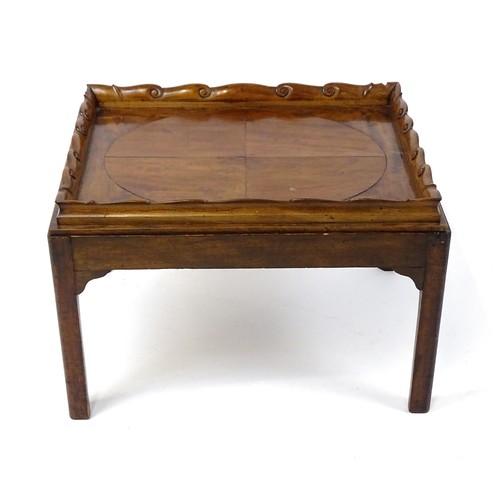 1745A - A Georgian Irish tray top table with a scrolled carved tray raised on a peg jointed base. 29